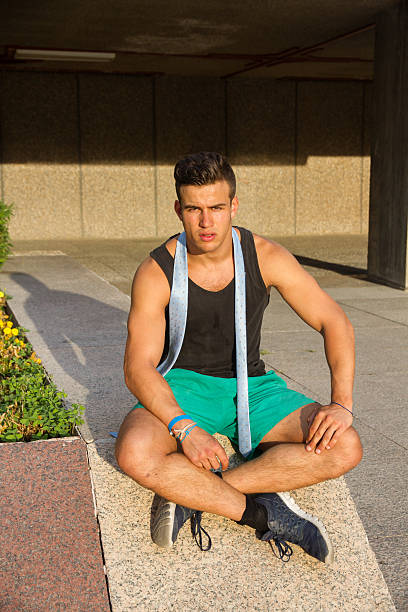 istock Strong and muscular young man posing on the street. 614123492