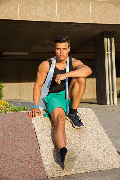 istock Strong and muscular young man posing on the street. 614123508