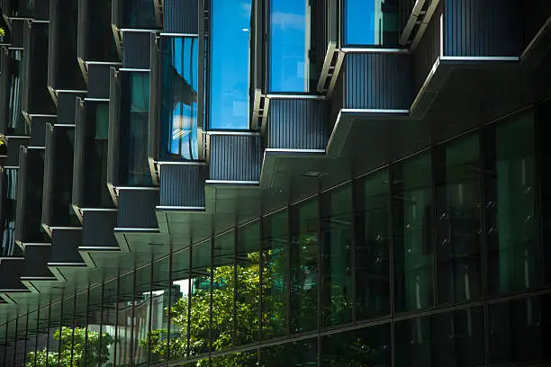 Reflective zig-zag wall of an office building in the City of London.