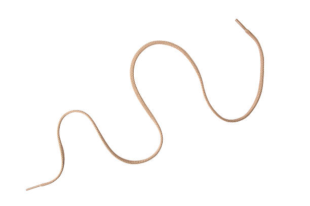 Tan Shoelace curved - isolated A tan colored shoelace, curved, isolated on white shoelace stock pictures, royalty-free photos & images