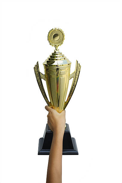 istock Gold trophy for champion cup on young girl hand 614125192