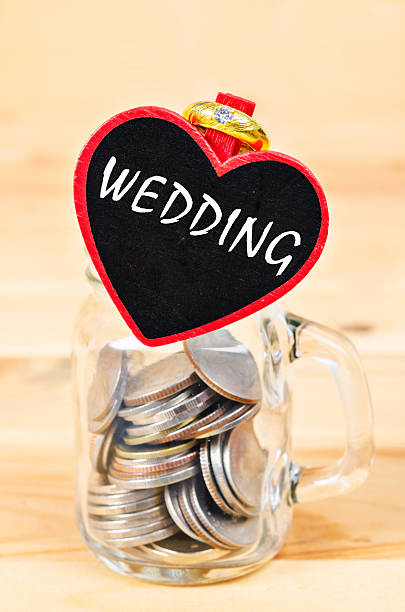 istock Savings in glass bank and Wedding Ring. 614125456