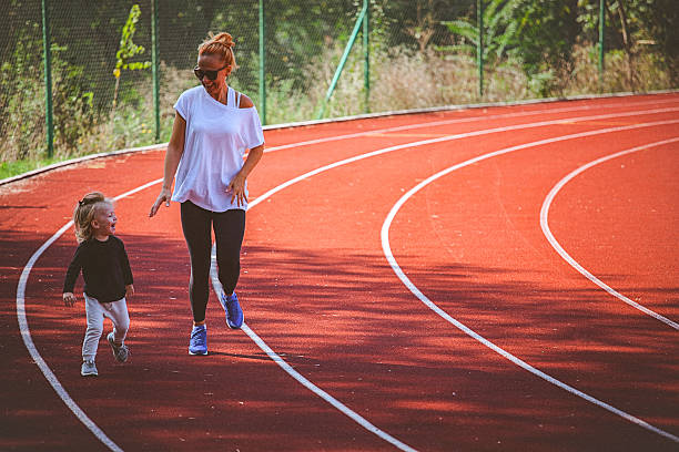 istock Me and my mom sprinting on the running track. 614126566