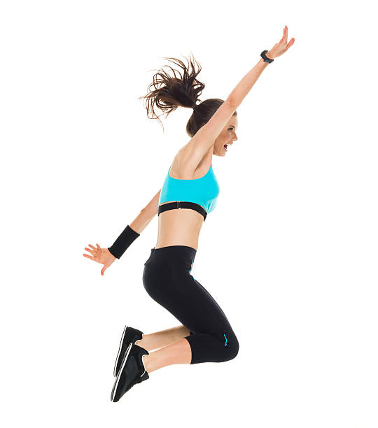 istock Smiling sports woman jumping 614127212