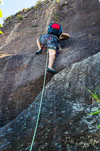 Young Brazilian man climbing the Sugarloaf mountain.