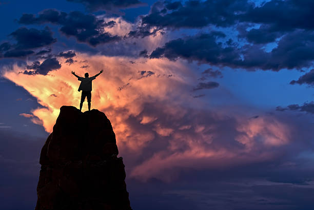 istock Man with arms raised in the sky winner success concept 614128404