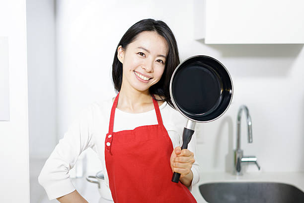 Woman holding frying pan