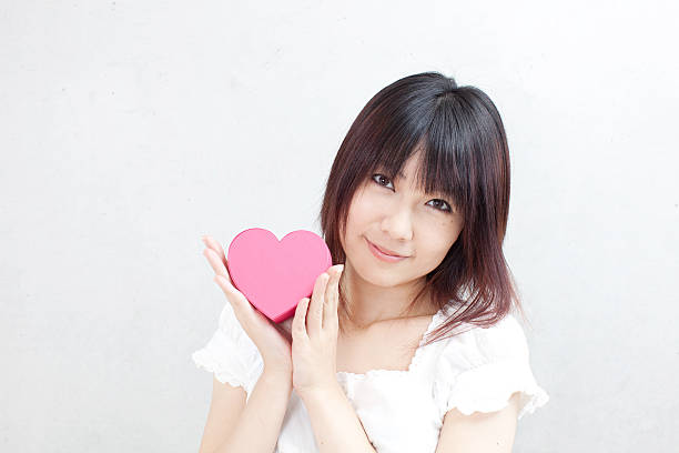 istock Woman holding a heart-haped box 614129242