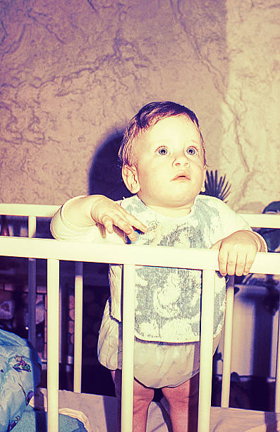 Vintage cute little boy in his cradle