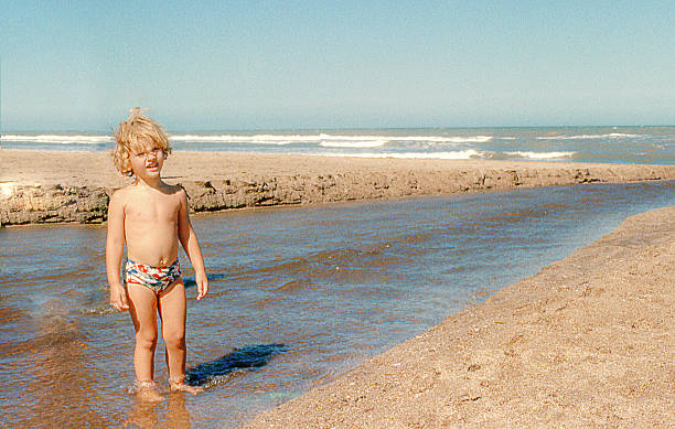 istock cute blonde child at the beach 614129558