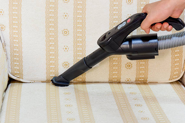 istock Use a vacuum cleaner to clean the sofa. 614129722