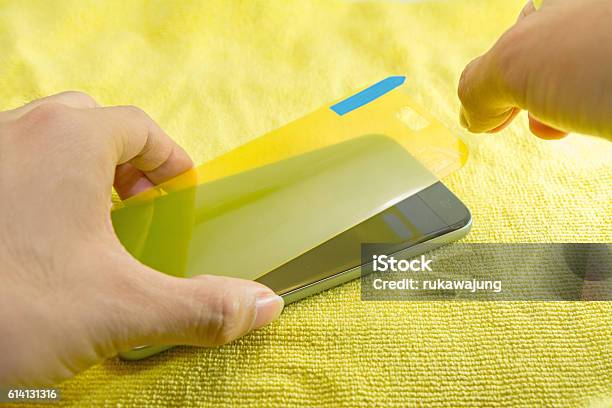 Apply The Smart Phone Screen Protect Stock Photo - Download Image Now - Protective Workwear, Protection, Device Screen