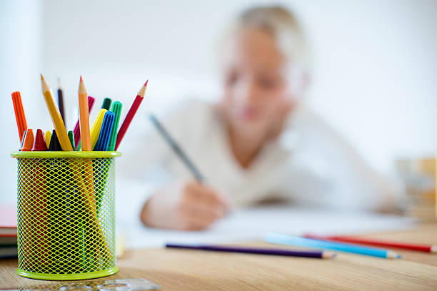 Multi color pencils in a pencil stand.
