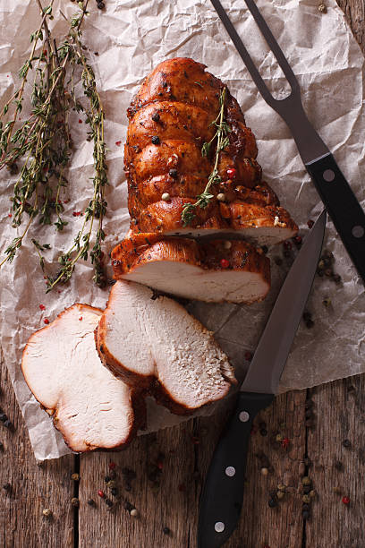 istock rustic food: roasted turkey breast close-up. vertical top view 614135754
