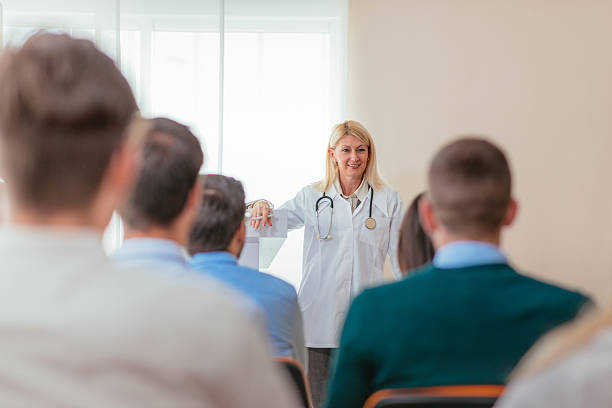 istock Doctor and her med students in lecture hall 614135988