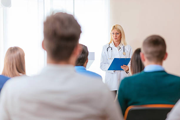 istock Professor and her med students in lecture hall 614136496