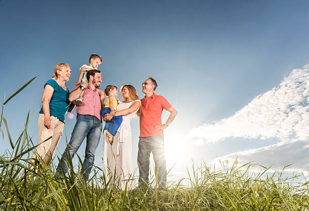 istock Below view of smiling multi-generation family communicating in nature. 614136802