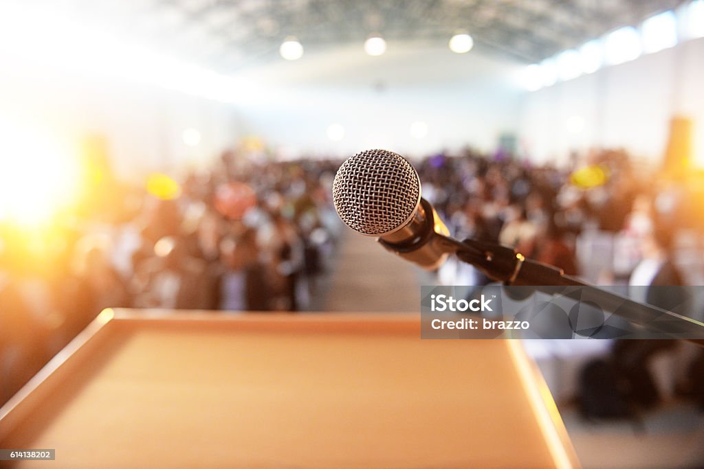 Mikrofon vor dem Podium mit Menschenmenge im Hintergrund - Lizenzfrei Mikrofon Stock-Foto