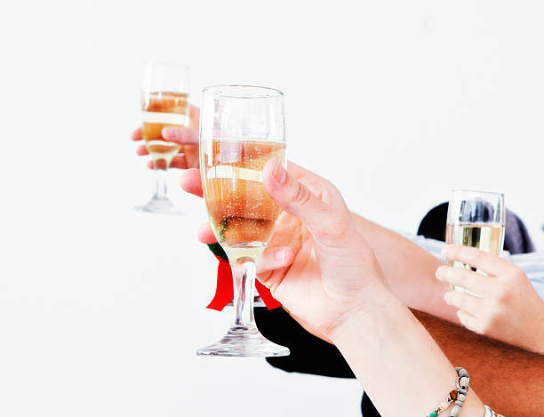 istock Hands raised in a celebratory champagne toast 614138438