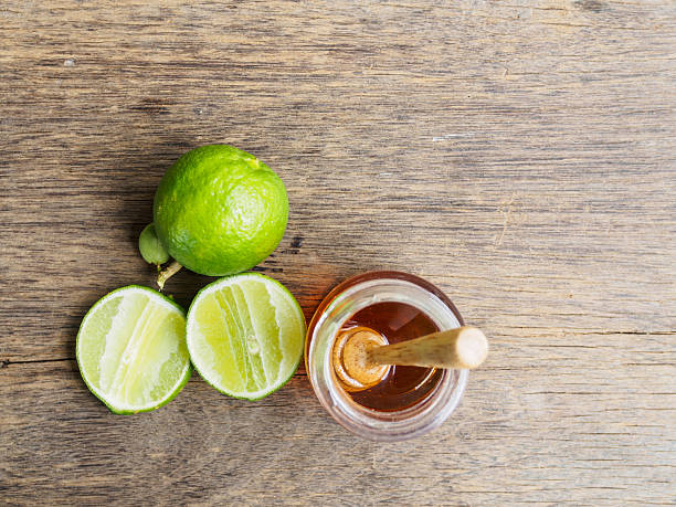 istock Top view fresh lime slice and honey in bottle glass 614138714