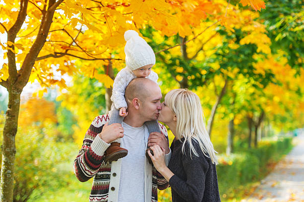 Family portrait of the father and daughter Family portrait of the father and daughter against the background of Indian summer. Walk in the autumn park. three way kiss stock pictures, royalty-free photos & images