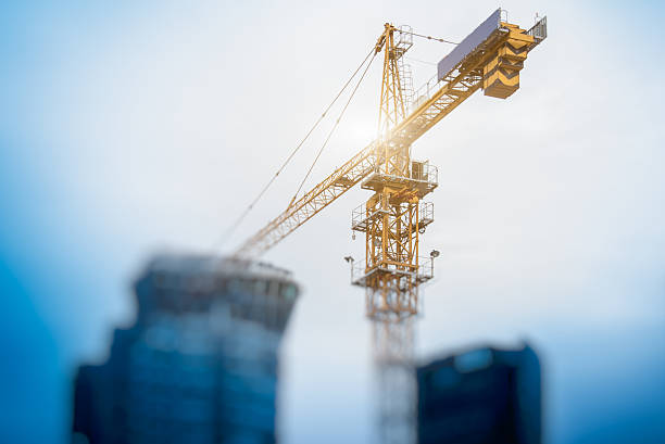 Low Angle View Of Cranes against skyline stock photo