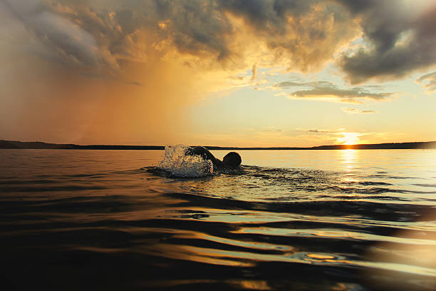 istock The strong man is swimming in the lake 614139380