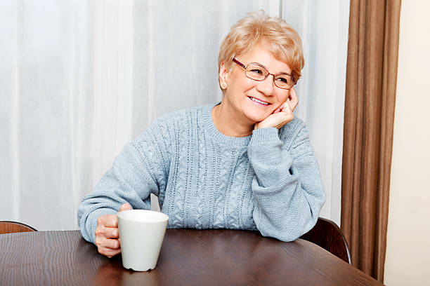 istock Senior woman drinking coffee or tea 614141256