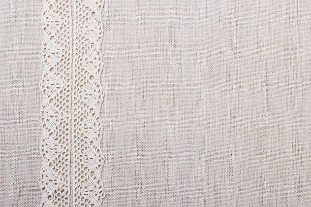 istock Lace ribbon on linen cloth background 614144706