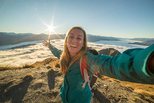 istock Caucasian female takes selfie on mountain summit 614146180