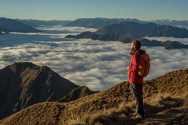 istock Hiker on moutain top contemplates view 614146414