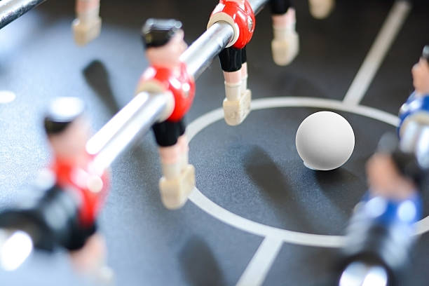 istock Football table game players suggesting team coaching 614146942