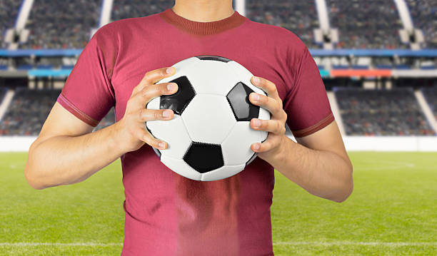 istock soccer player holding the ball 614148644