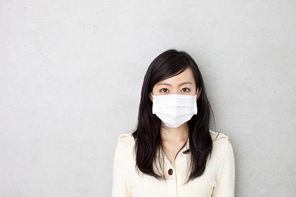 Woman wearing a surgical mask stock photo
