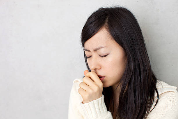 Woman coughing stock photo