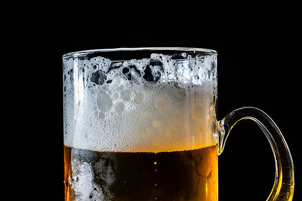 istock Large glass beer isolated on black 614150214