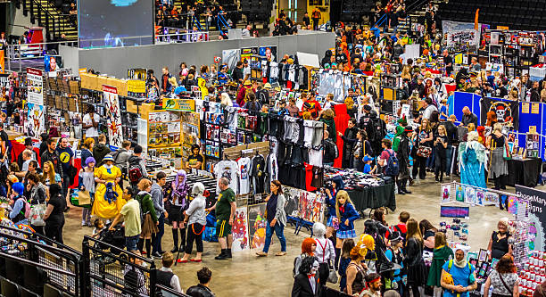 Busy stalls at Yorkshire Cosplay Convention Sheffield, United Kingdom - June 11, 2016: Crowds enjoying the stalls selling character goods and costumes  at the Yorkshire Cosplay Convention at Sheffield Arena cosplay photos stock pictures, royalty-free photos & images