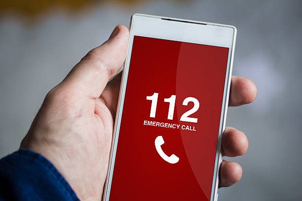 istock holding emergency call smartphone 614153026