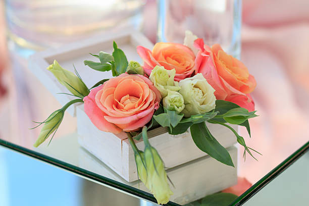 istock wooden box with fresh flowers stands on a mirrored table 614153076