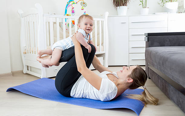 istock Beautiful mother practicing yoga with her baby boy 614154010