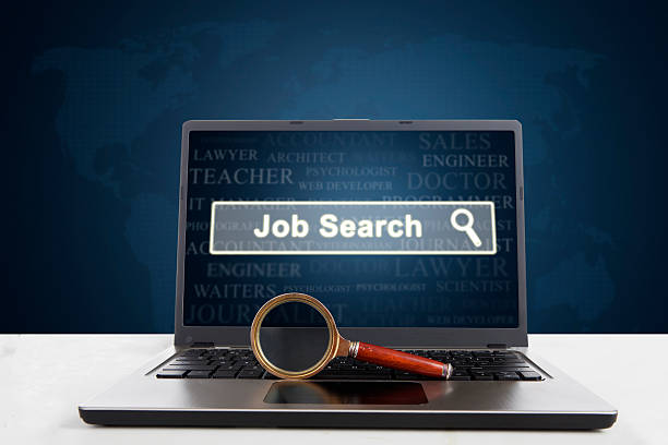 istock Laptop with job search text and magnifier 614154140