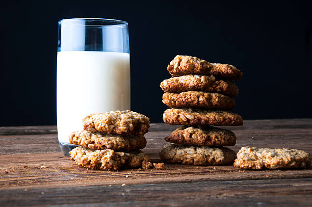 istock Milk and cookies on wooden table. Copyspace 614207804
