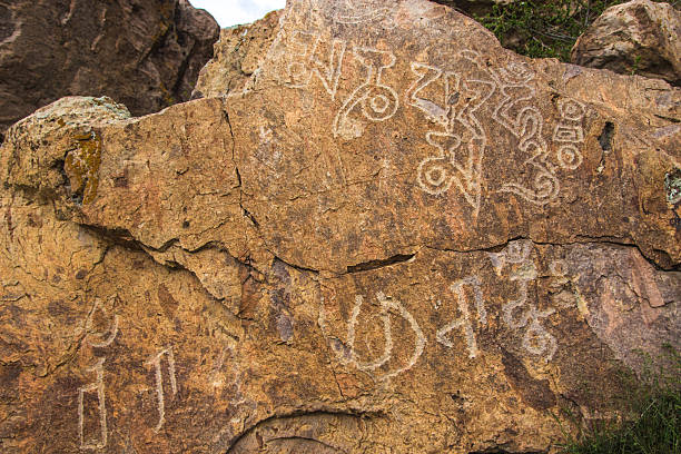 istock Petroglyphs on the stone in Tamgaly, Kazakhstan 614208018