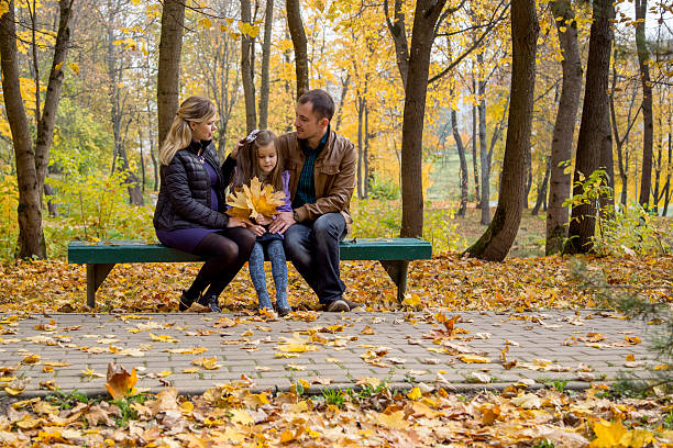 Happy pregnant family in autumn nature stock photo