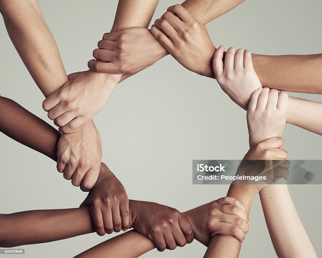 United through their diversity Cropped shot of a diverse group of unidentifiable people holding hands in a circle Circle Stock Photo