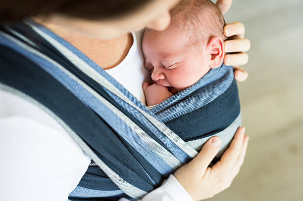 istock Unrecognizable young mother with her son in sling 614211968