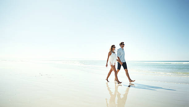 istock Enjoying a romantic walk on the beach 614213340
