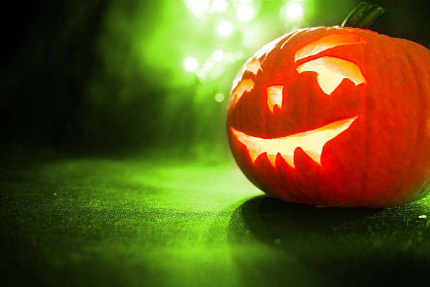 istock Halloween pumpkin with green bokeh background 614213458
