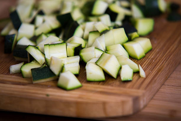 istock close up on zucchini pieces on wood 614214326