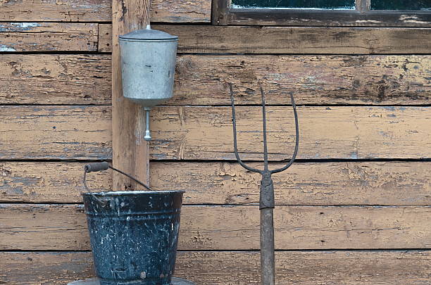 istock washbasin aluminum, enamel bucket and a pitchfork 614215556